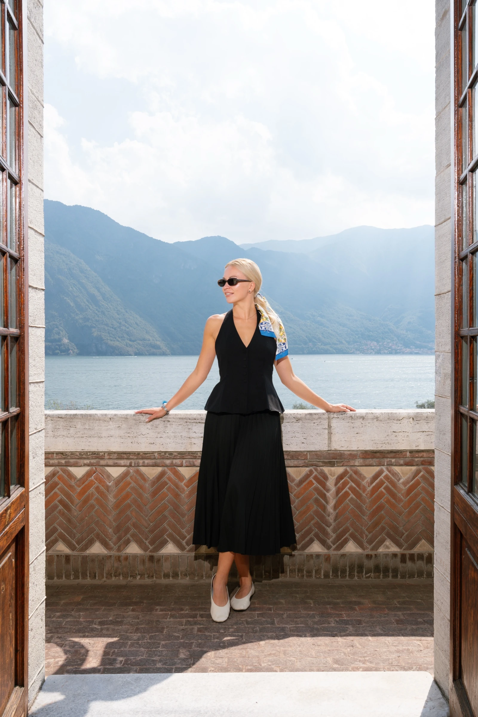 Anastasia, Venue Manager of Villa Pessina, on a balcony overlooking Lake Como